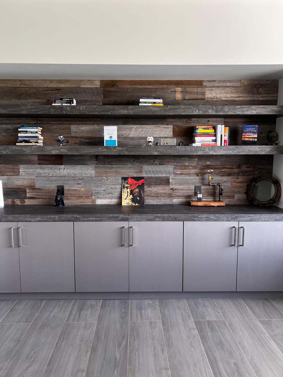 Grey reclaimed wood accent wall installation showing natural silver patina